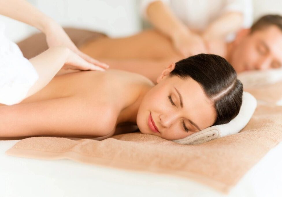 Couple enjoying relaxing spa back massages